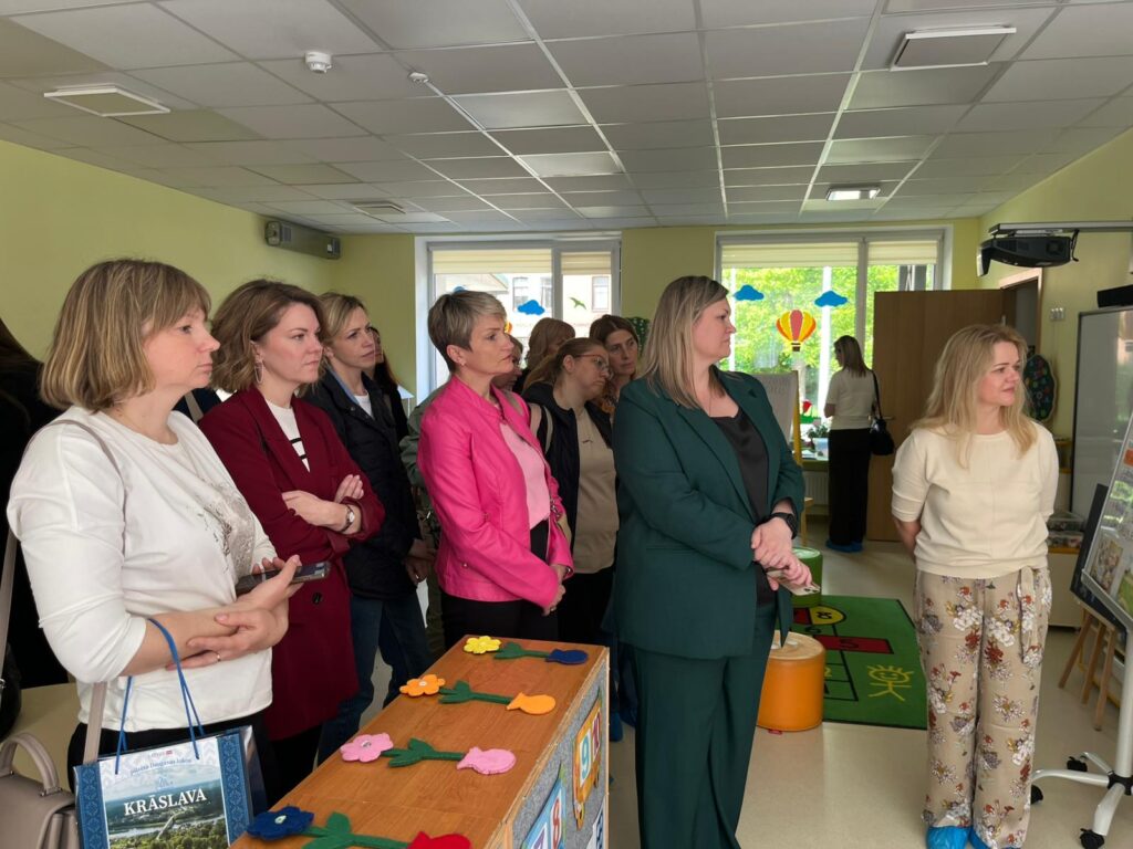 Group of professionals attending a workshop or seminar in a brightly lit classroom, engaging in discussions and observing activities. Group of professionals attending a workshop or seminar in a brightly lit classroom, engaging in discussions and observing activities.