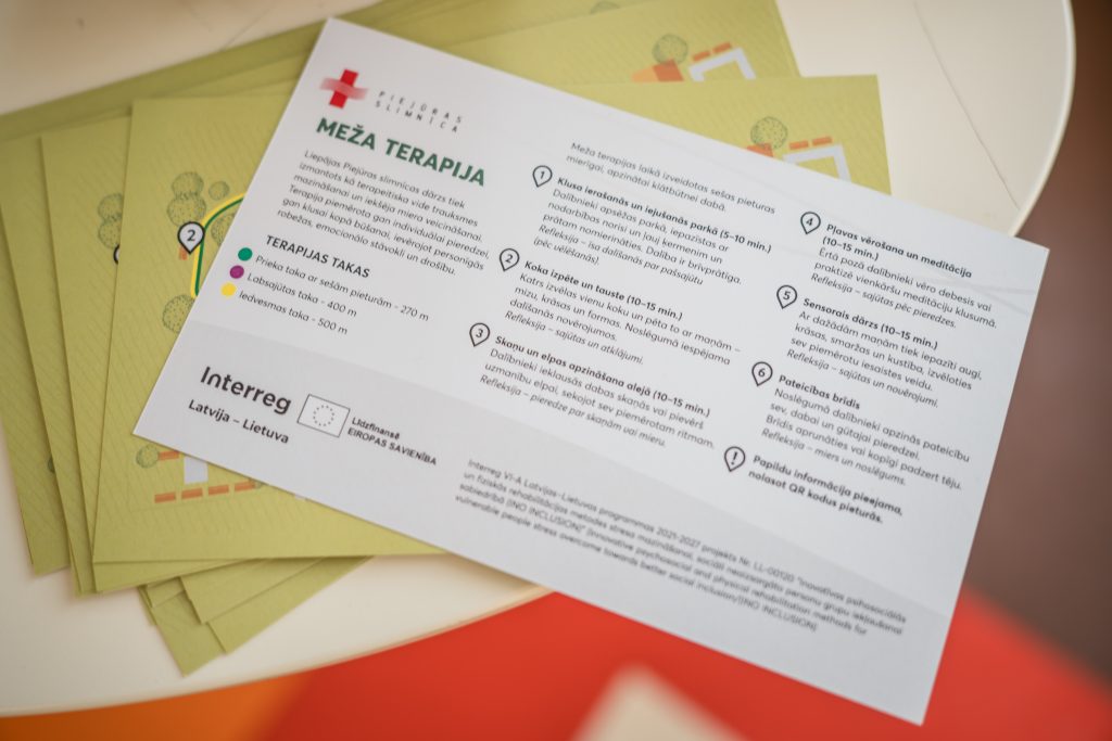 Informative brochure detailing "Meža Terapija" (Forest Therapy) methods, including therapeutic paths, activities for emotional and physical rehabilitation, and promoting social inclusion for vulnerable individuals. The design features a green background with illustrations and outlines the steps involved in the therapy process. Informative brochure detailing "Meža Terapija" (Forest Therapy) methods, including therapeutic paths, activities for emotional and physical rehabilitation, and promoting social inclusion for vulnerable individuals. The design features a green background with illustrations and outlines the steps involved in the therapy process.
