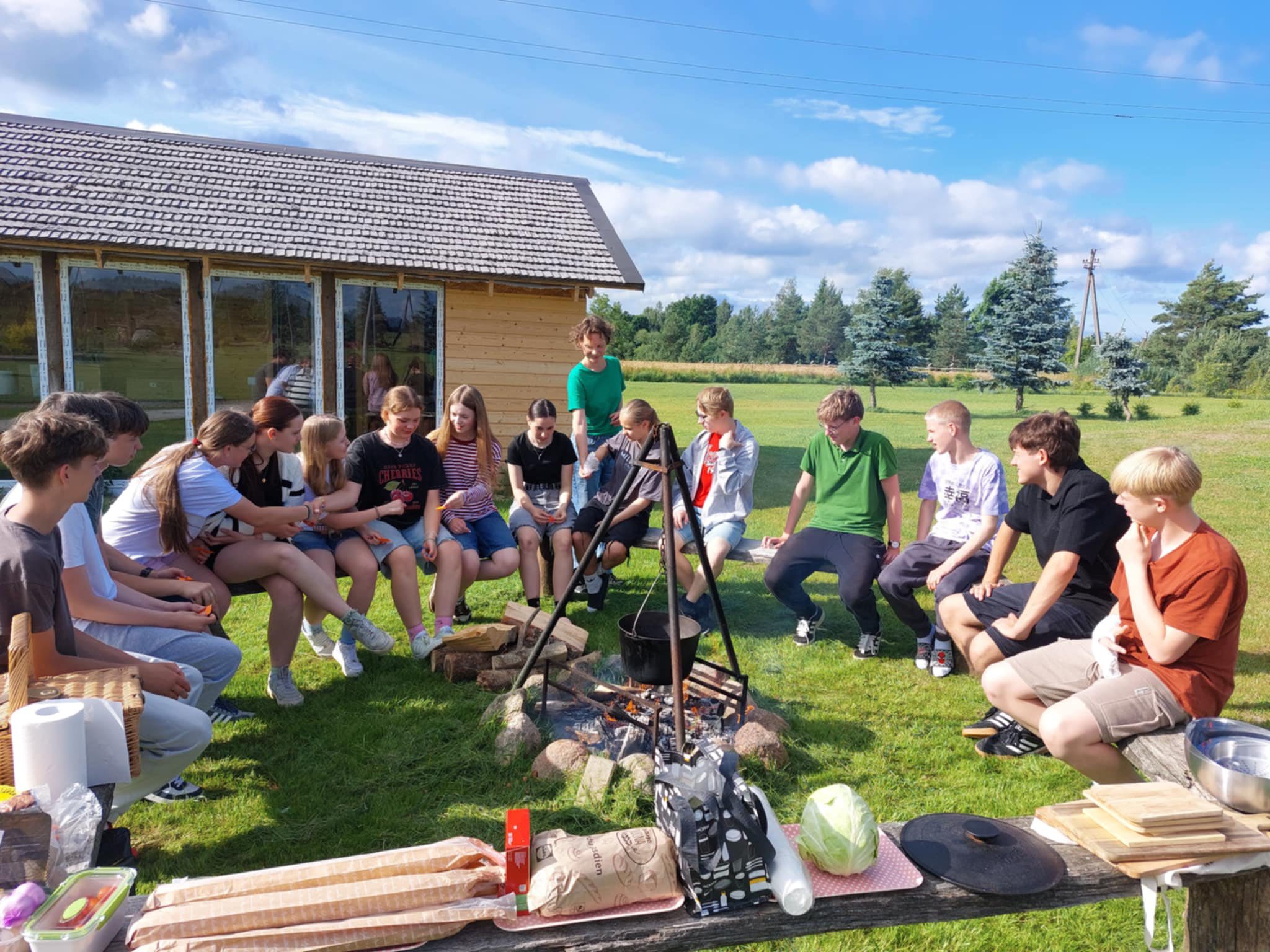 Camp participants sitting around the fireplace