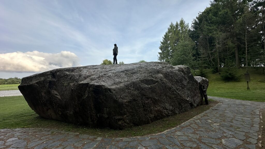 Photo of stone with person on it standing