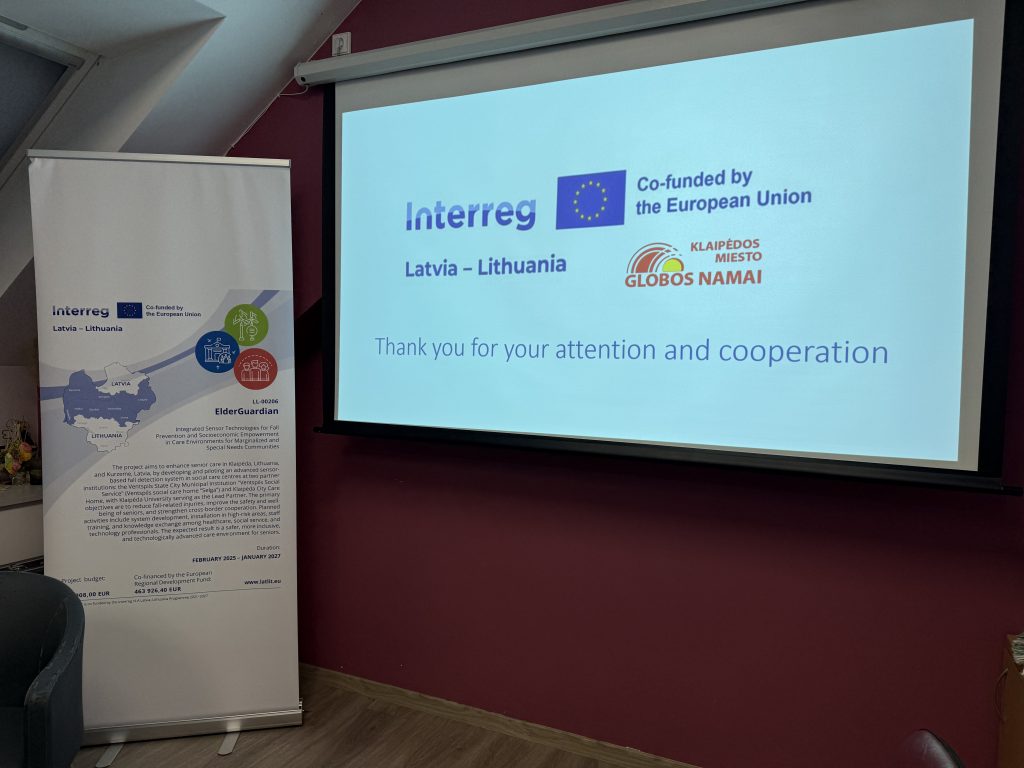 Banner display at a conference featuring the Interreg logo, EU funding acknowledgment, and a message of thanks for cooperation, set against a modern interior backdrop.