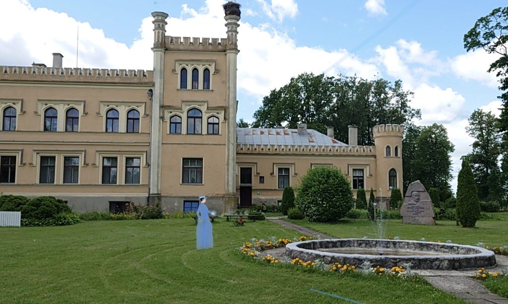 Historic castle with turrets and a manicured lawn, featuring a decorative fountain and colorful flower beds in the foreground, under a partly cloudy sky. Historic castle with turrets and a manicured lawn, featuring a decorative fountain and colorful flower beds in the foreground, under a partly cloudy sky.