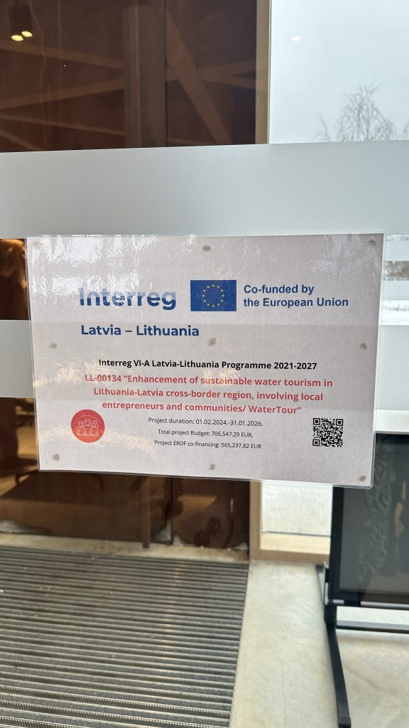 Sign promoting the Interreg Latvia-Lithuania program, detailing its objectives and funding by the European Union, displayed in a public area. Sign promoting the Interreg Latvia-Lithuania program, detailing its objectives and funding by the European Union, displayed in a public area.
