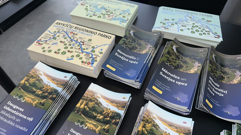 Collection of informational brochures and maps showcasing local attractions and natural landscapes, arranged on a table for visitors. Collection of informational brochures and maps showcasing local attractions and natural landscapes, arranged on a table for visitors.