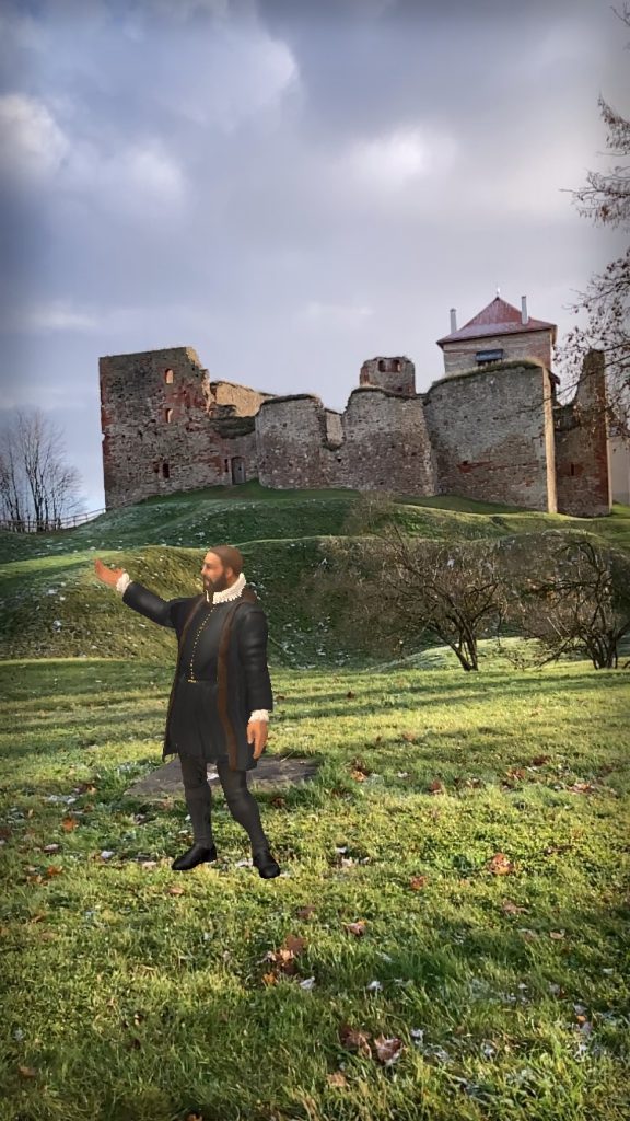 A person standing on a grassy area in front of a historic castle ruins, gesturing towards the structure. The scene captures the blend of nature and history, showcasing the castle's weathered walls and surrounding landscape. A person standing on a grassy area in front of a historic castle ruins, gesturing towards the structure. The scene captures the blend of nature and history, showcasing the castle's weathered walls and surrounding landscape.
