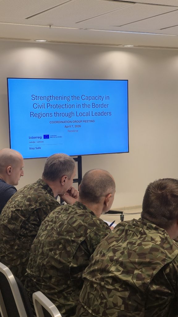 Participants in military uniforms attending a coordination group meeting focused on enhancing civil protection in border regions, with a presentation titled "Strengthening the Capacity in Civil Protection through Local Leaders" displayed on a screen. The meeting took place in Rezekne on April 17, 2026. Participants in military uniforms attending a coordination group meeting focused on enhancing civil protection in border regions, with a presentation titled "Strengthening the Capacity in Civil Protection through Local Leaders" displayed on a screen. The meeting took place in Rezekne on April 17, 2026.
