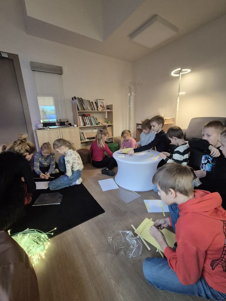 Children engaged in a creative activity in a cozy indoor setting, surrounded by books and soft lighting, showcasing teamwork and artistic expression. Children engaged in a creative activity in a cozy indoor setting, surrounded by books and soft lighting, showcasing teamwork and artistic expression.