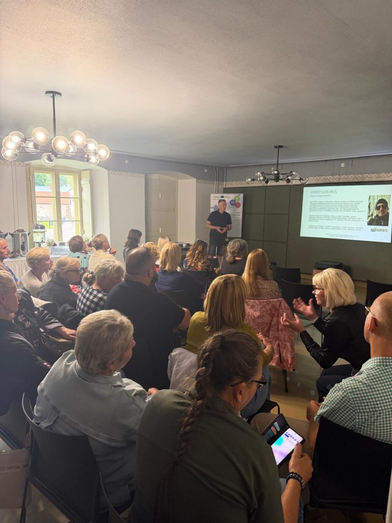 Audience engaged in a lecture on sustainable park management at Jēkabpils History Museum, featuring a speaker presenting information on effective park management practices.