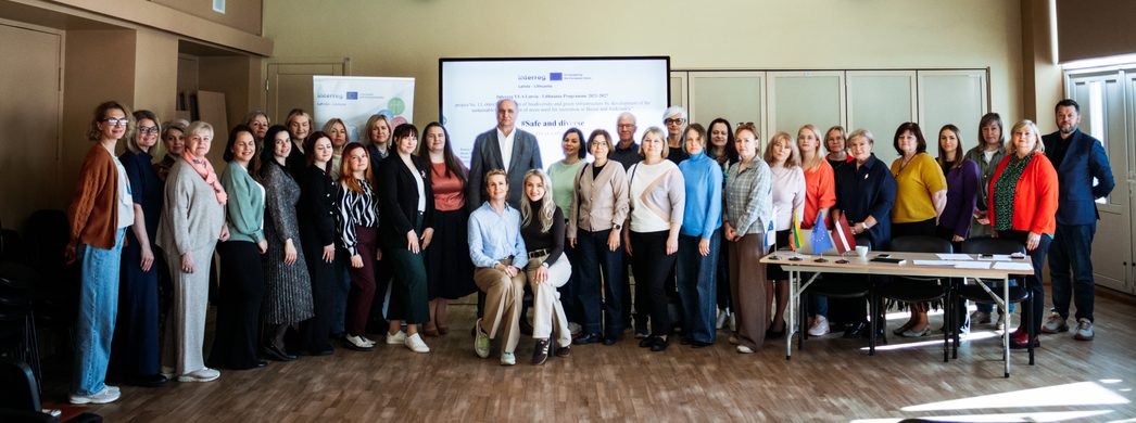 Group photo of participants at an international conference focused on collaboration and innovation, featuring diverse attendees from various backgrounds, gathered in a modern conference room with a presentation screen and flags. Group photo of participants at an international conference focused on collaboration and innovation, featuring diverse attendees from various backgrounds, gathered in a modern conference room with a presentation screen and flags.