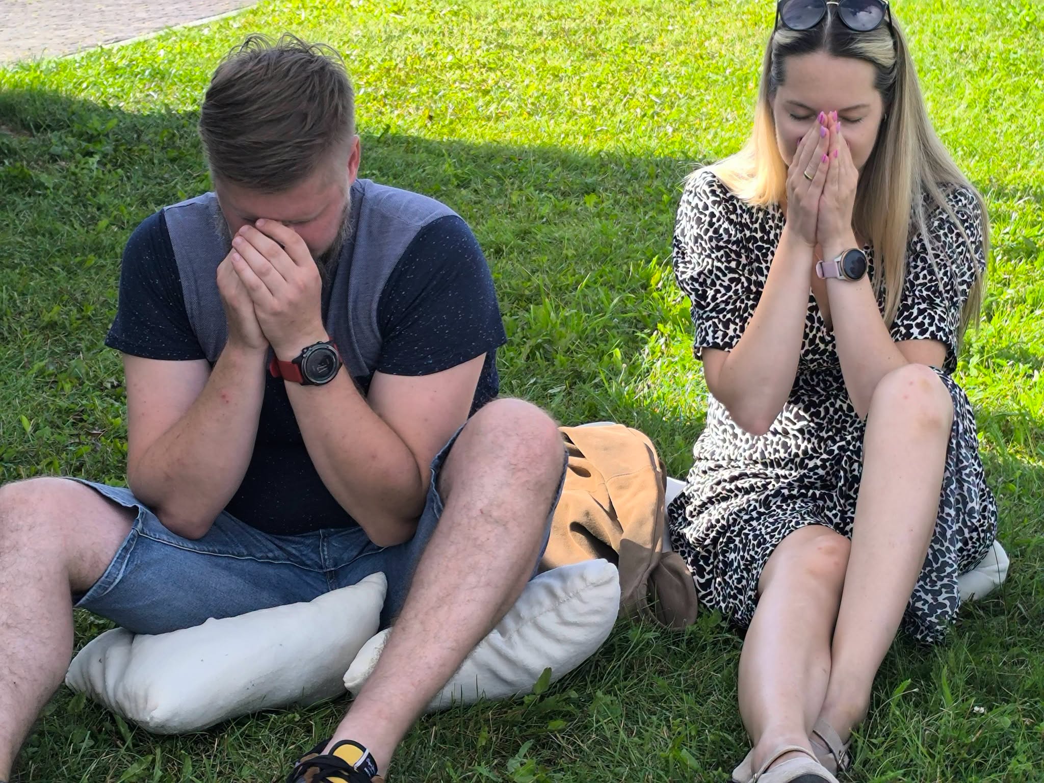 Participants engaged in a reflective exercise during the "Bee Guide" educational workshop, sitting on grass with hands covering their faces, fostering mindfulness and connection to nature. Participants engaged in a reflective exercise during the "Bee Guide" educational workshop, sitting on grass with hands covering their faces, fostering mindfulness and connection to nature.