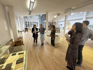 Group of museum visitors engaging with exhibits during the MATOMI project, focusing on enhancing visitor experiences through modern interpretations of historical artifacts.