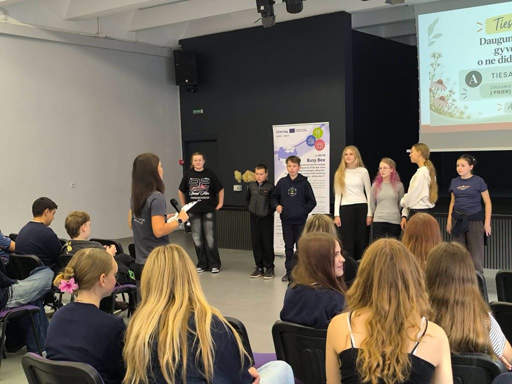 Students participating in a presentation about the "Bee Garden" at the Youth Garden, showcasing their engagement and educational activities related to gardening and environmental awareness.