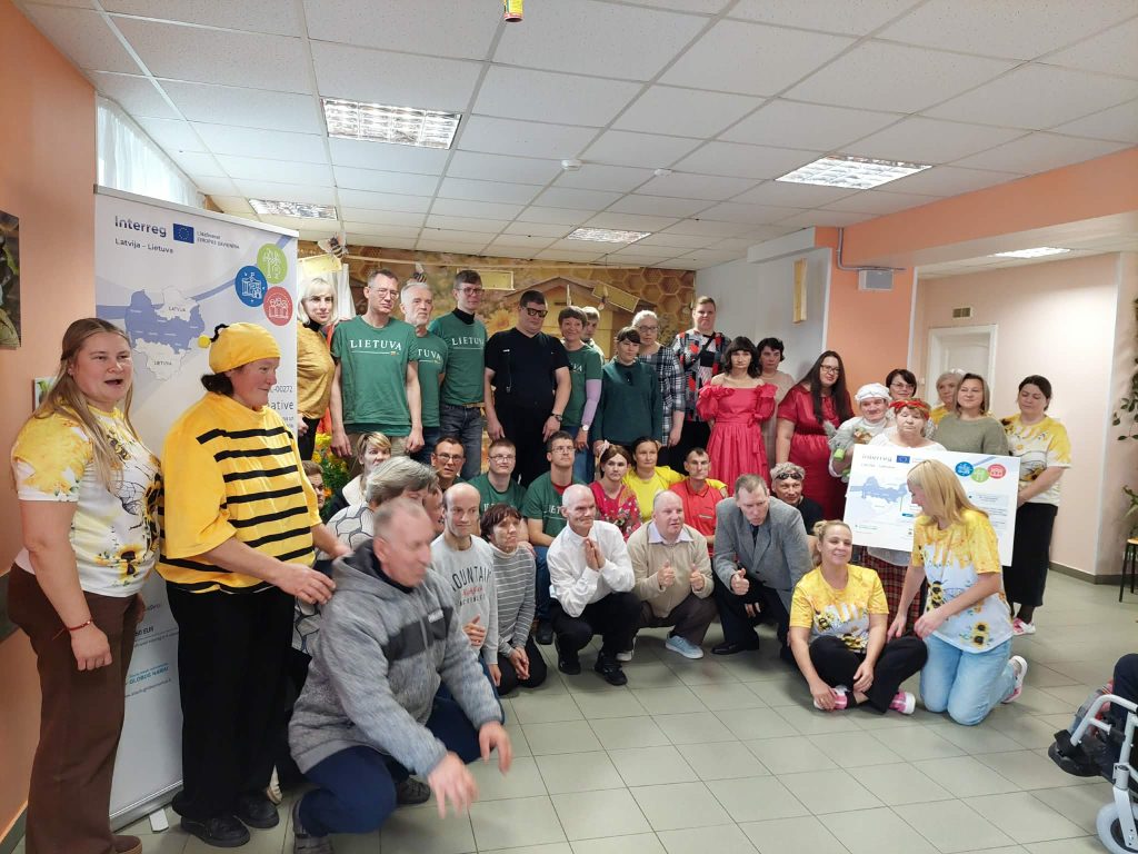 Group photo of participants at the SoCreative Project Meeting in Latvia, showcasing creativity and collaboration. Attendees wear colorful outfits, including bee-themed costumes, and pose together in a lively atmosphere. A banner representing the Interreg initiative is displayed in the background, highlighting the project's focus on togetherness and community engagement. Group photo of participants at the SoCreative Project Meeting in Latvia, showcasing creativity and collaboration. Attendees wear colorful outfits, including bee-themed costumes, and pose together in a lively atmosphere. A banner representing the Interreg initiative is displayed in the background, highlighting the project's focus on togetherness and community engagement.