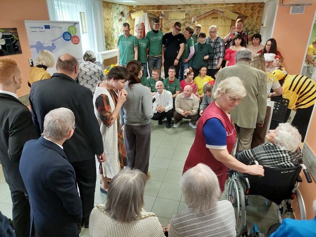 Group photo from the SoCreative Project meeting in Latvia, showcasing participants engaged in creative activities. Attendees include individuals of various ages, some dressed in colorful costumes, emphasizing themes of creativity and togetherness. The setting features a warm, welcoming environment with decorative elements related to beekeeping. Group photo from the SoCreative Project meeting in Latvia, showcasing participants engaged in creative activities. Attendees include individuals of various ages, some dressed in colorful costumes, emphasizing themes of creativity and togetherness. The setting features a warm, welcoming environment with decorative elements related to beekeeping.